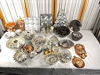 Entire collection of copper and aluminum baking molds laid out on table