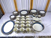All 77 pieces displayed including platter, plates, bowls, cups, creamer, gravy boat, sugar bowl