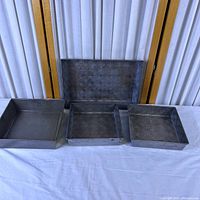 All four patterned metal baking pans displayed
