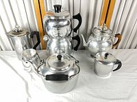 Group shot of all six aluminum percolators, kettles and pitcher