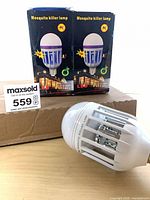 Two retail boxes and one lamp displayed