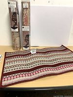 Overall lot showing two wallpaper rolls and mat