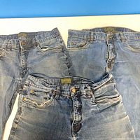 Front view of three blue jeans