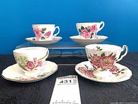 Front view of four teacup and saucer sets