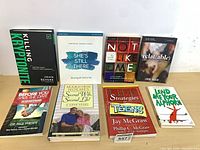 Front covers of all eight books displayed upright