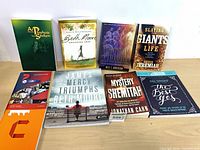 Front covers of nine books laid out
