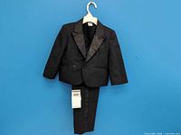 Full view of complete tuxedo set on hanger