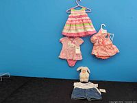 Full lot overview showing dresses, bodysuit, plush, shorts and shirt