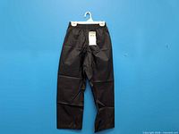 Front view of black splash pants hanging