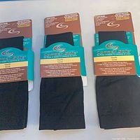 Front view of three packaged Copper Sole knee-high socks