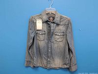 Front of denim shirt showing overall appearance and pockets