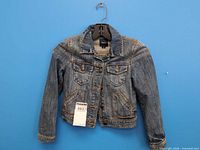 Front view of GapKids denim jacket on hanger with tag visible
