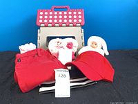 Group shot of all items: stool, jeans, purse, cap, plush doll