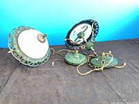 Two green metal and glass ceiling fixtures with chains and canopies