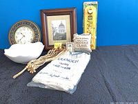 All items arranged: clock, frame, bowl, lace cloth, rope tassel, plaque, level