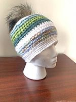 Front side view of striped knit beanie on mannequin head