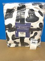 Front of sealed package showing blanket hoodie and label