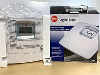Scale in foam packaging next to retail box front