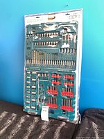 Front view of sealed Makita 124-piece accessory kit showing drill bits, driver bits, sockets and adapters