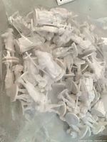 Multiple white plastic medieval figurines inside a clear bag