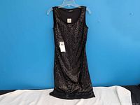 Front view showing full sequin coverage and attached tag