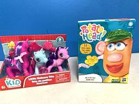 Front view of sealed Little Unicorn Trio and Mrs. Potato Head boxes