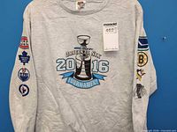 Full front view of heather grey long sleeve T-shirt with Wave Hockey Original Six 2016 Tournament graphic