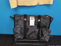 Front view of Thirty-One black and grey utility tote with lot tag