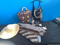 overview showing hat, handbag, top, skirt, necklaces