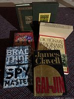 Front view of all six books in lot