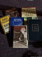 All six books spread on surface showing covers and titles
