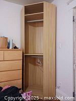 Full view of IKEA corner wardrobe showing shelf and hanging rod