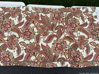 Paisley patterned side of comforter or sham in red, green, gold on cream background
