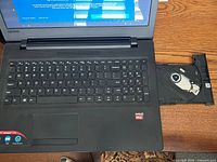 Laptop open, keyboard layout, DVD optical tray extended