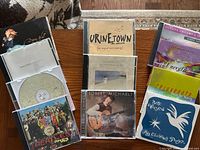 All ten CDs arranged in three columns showing covers and two open cases displaying discs.