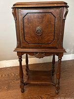 Front view showing cabinet door, pull, legs, and shelf