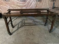 Full view of wooden wash tub stand showing overall structure and casters