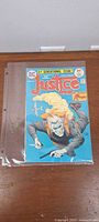 Front cover of Justice Inc. comic in protective sleeve