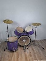 Full view of assembled purple Remo drum kit with cymbals and hardware