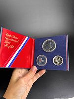 Open presentation folder showing three silver proof coins