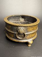 overall view of bronze incense burner showing tripod feet and ring handle