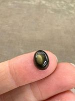 Close-up of the oval black star sapphire displaying the star effect