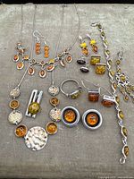 All items laid out showing both necklaces, bracelet, ring and five pairs of earrings