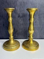 Front view of both brass candlesticks