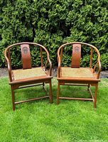Front view of both Chinese hardwood armchairs on lawn
