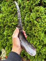 Full view of horn ladle front showing bowl and carved handle