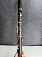 Close view of upper body showing rosewood grain and silver-tone key