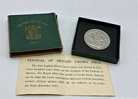 Coin in open presentation box beside lid and COA