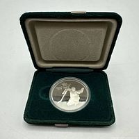 Coin in open green presentation case