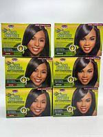 Front view of six sealed Olive Miracle relaxer kit boxes, showing Regular and Super variants